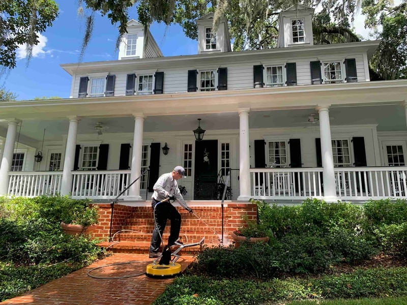 Pressure washing the brick walkway of a Central Florida home